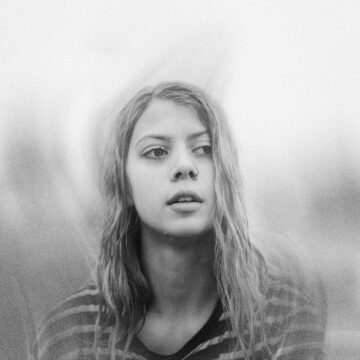 a black and white photo of a woman with long hair