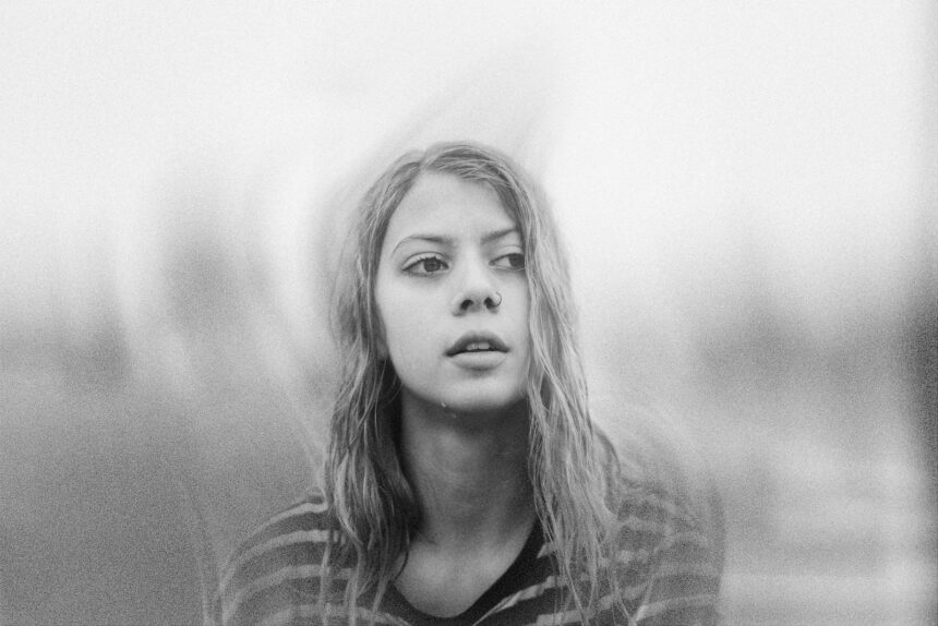 a black and white photo of a woman with long hair