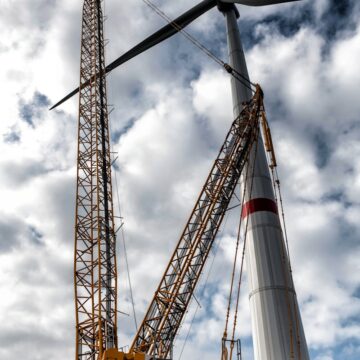 a large crane is standing next to a pile of rocks