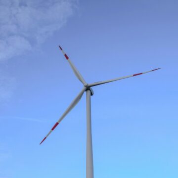 a wind turbine is shown against a blue sky