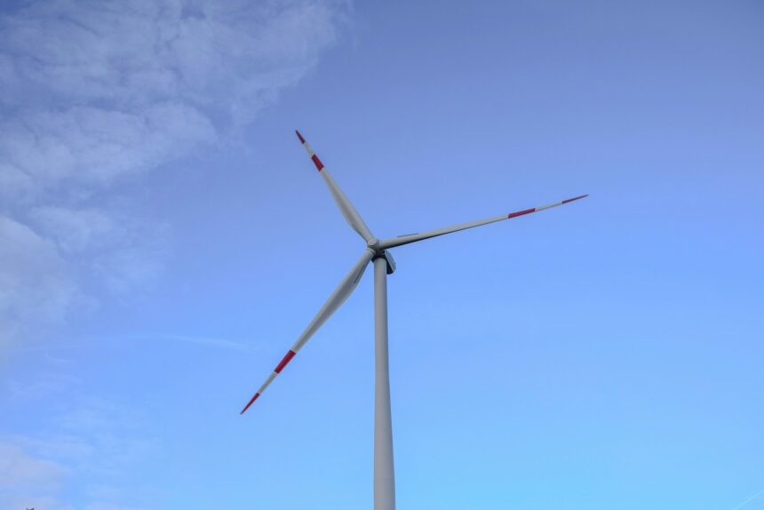 a wind turbine is shown against a blue sky