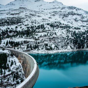 a large body of water surrounded by snow covered mountains