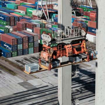 an overhead view of cargo containers and a crane