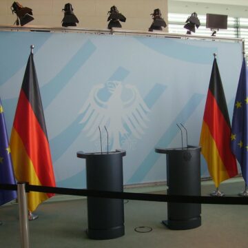 Six Assorted-color Flags Hanging on Gray Stainless Steel Poles