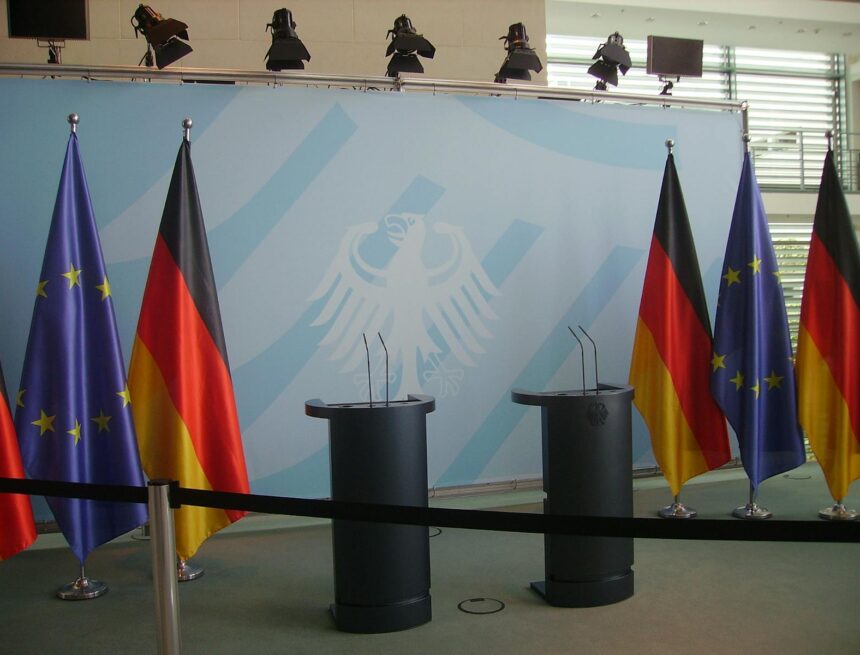 Photo by Wikimedia Commons Six Assorted-color Flags Hanging on Gray Stainless Steel Poles