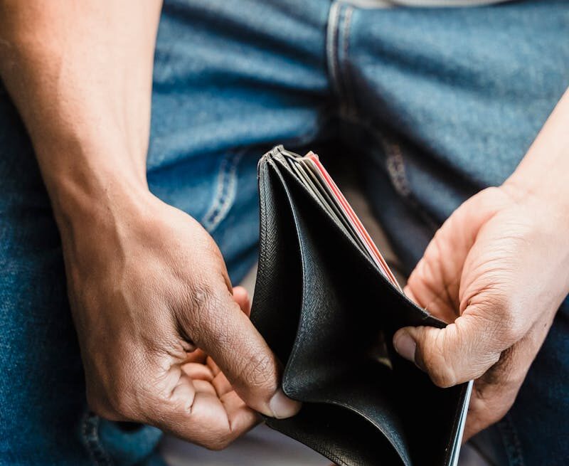 Photo by Nicola Barts A Person Holding a Wallet
