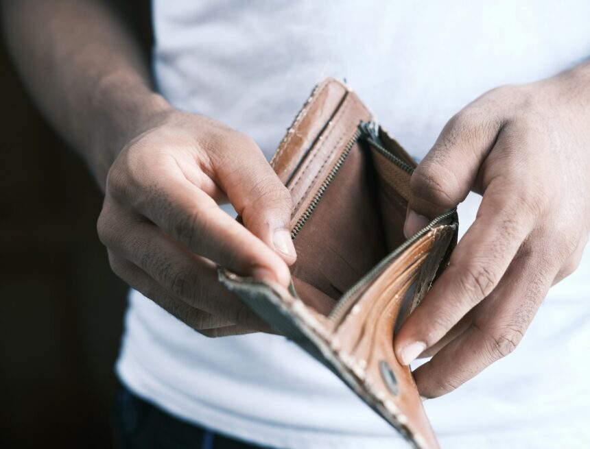 Photo by Towfiqu barbhuiya person holding brown leather bifold wallet