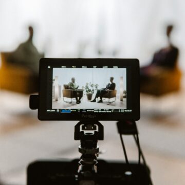 a tripod with a camera attached to it